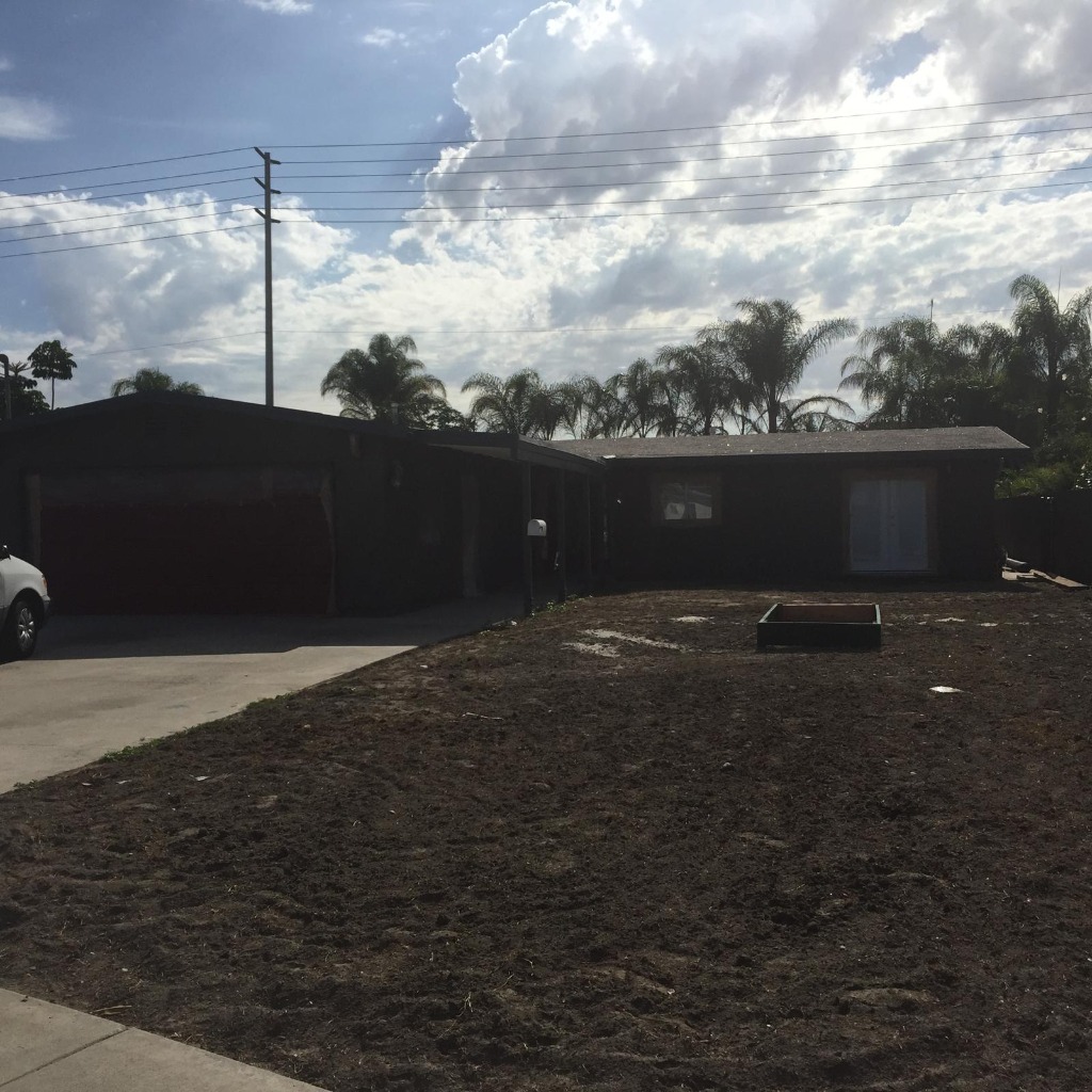 Before landscaping remodel showing dry untamed dirt yard and unfinished ground
